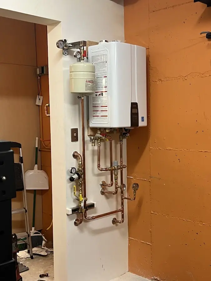 Plumbing technician inspecting water heater connections in Delhi